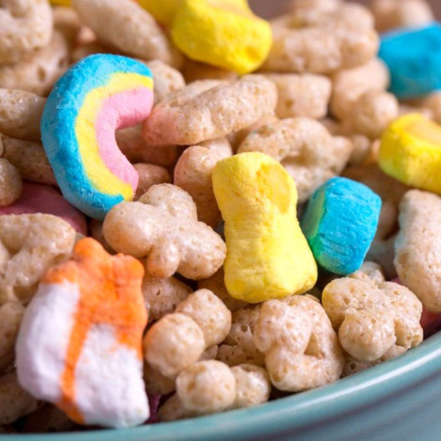 Un bol gris rapproché avec des céréales en forme de ronds, de trèfles et des petits petits marshmallows colorés 