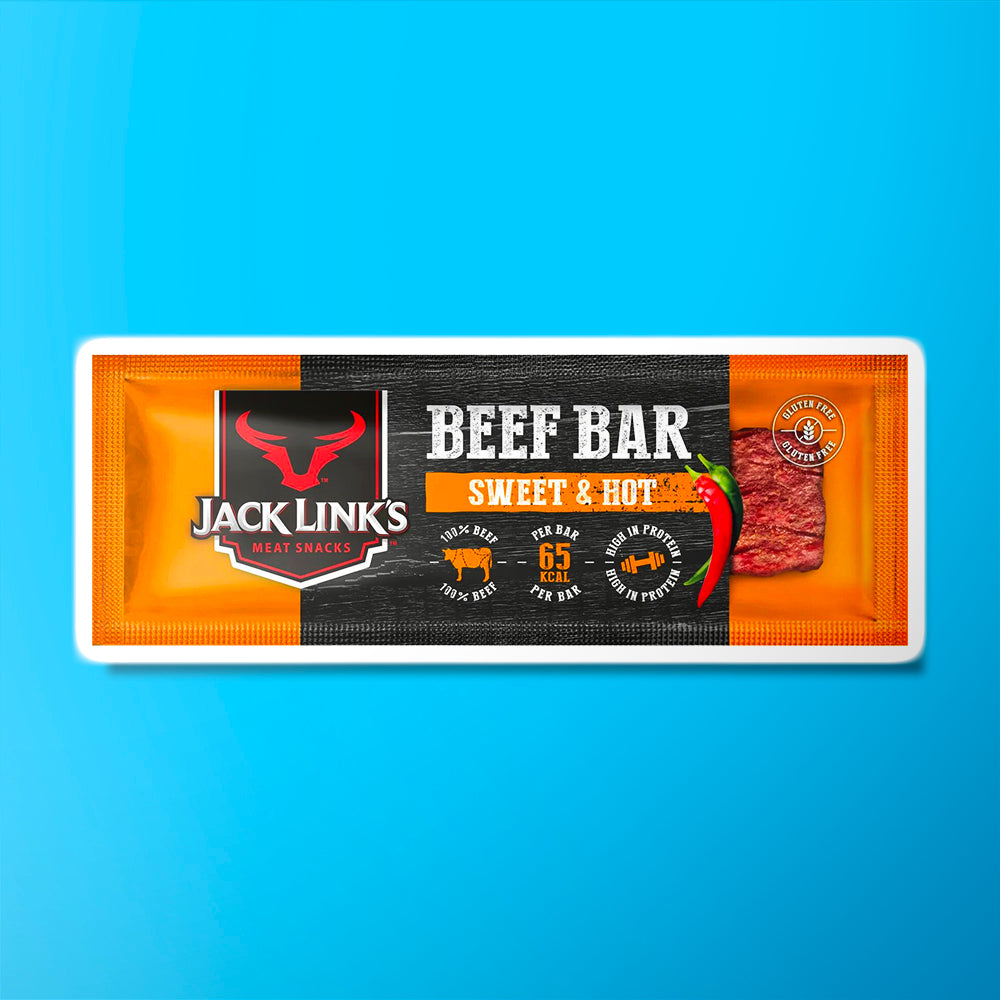 Un emballage orange et noire avec à gauche le symbole d’un taureau rouge et à droite un morceau de viande séchée en bar, le tout sur fond bleu