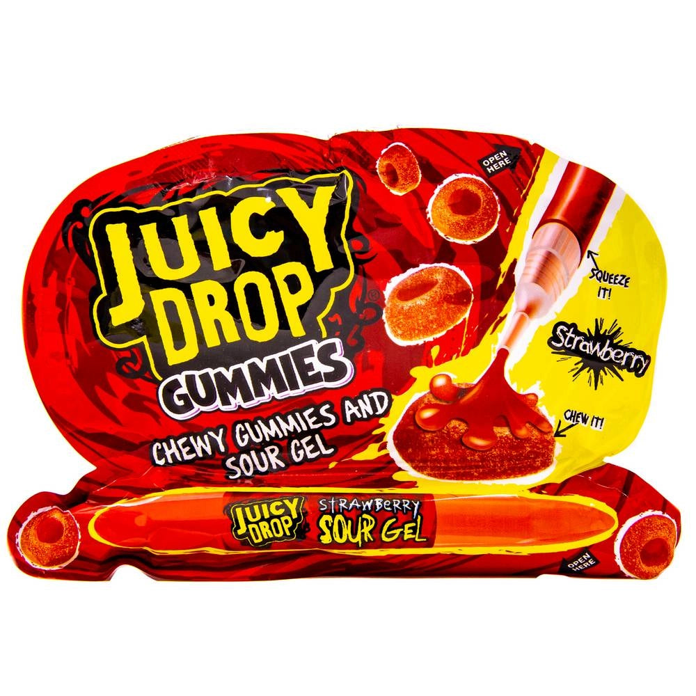 Un emballage rouge et jaune sur fond blanc avec en bas un stylo rouge et au-dessus des petits bonbons avec du jus qui sort du stylo